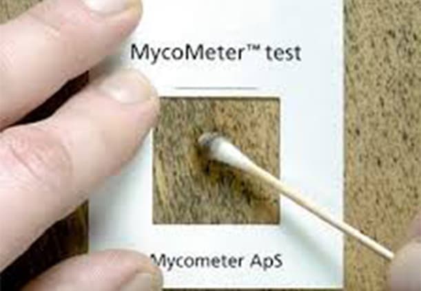 Technician cleaning joist bays and tight corners around plumbing