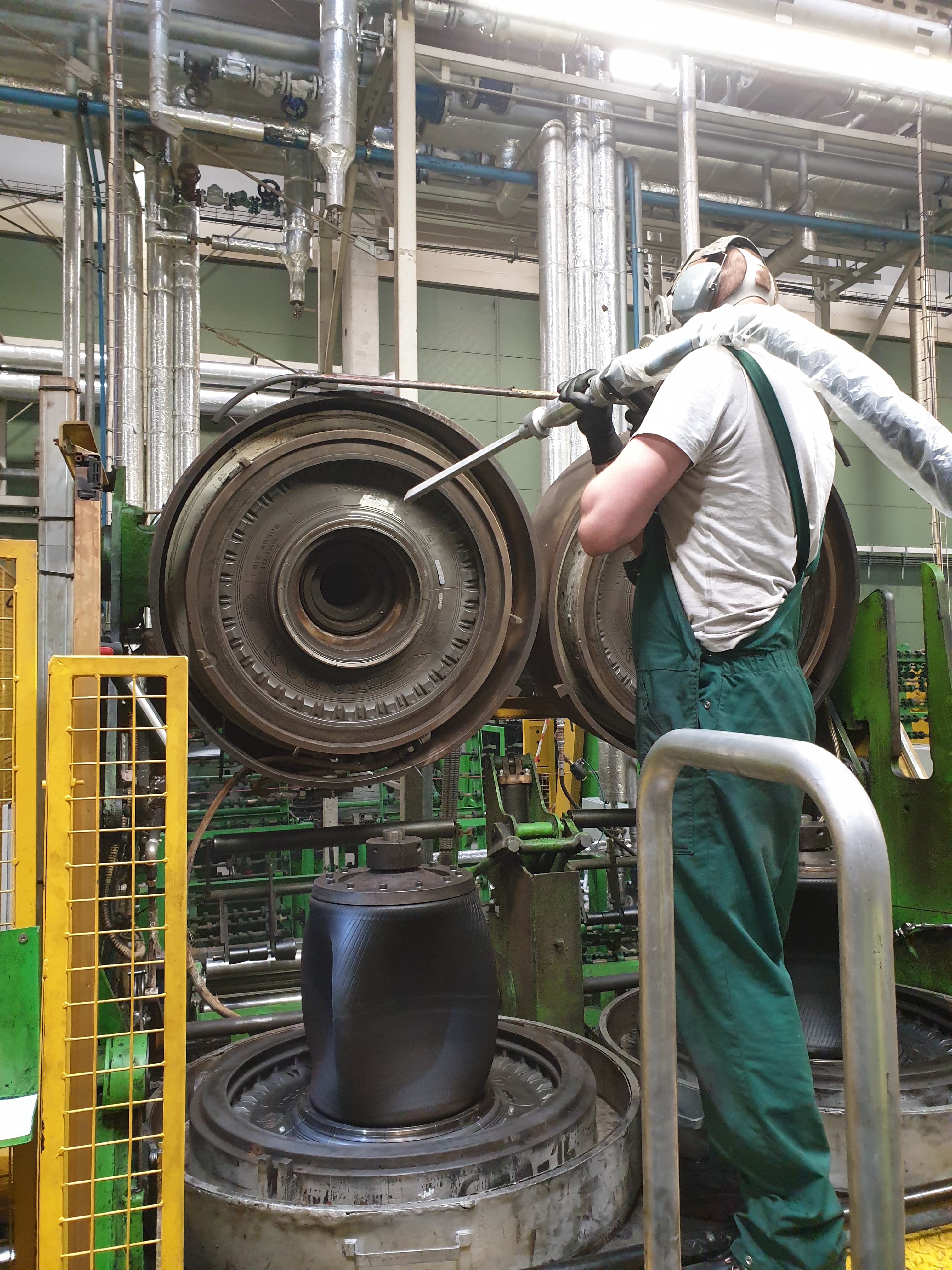 Technician dry-ice blasting tire mold halves on the press line